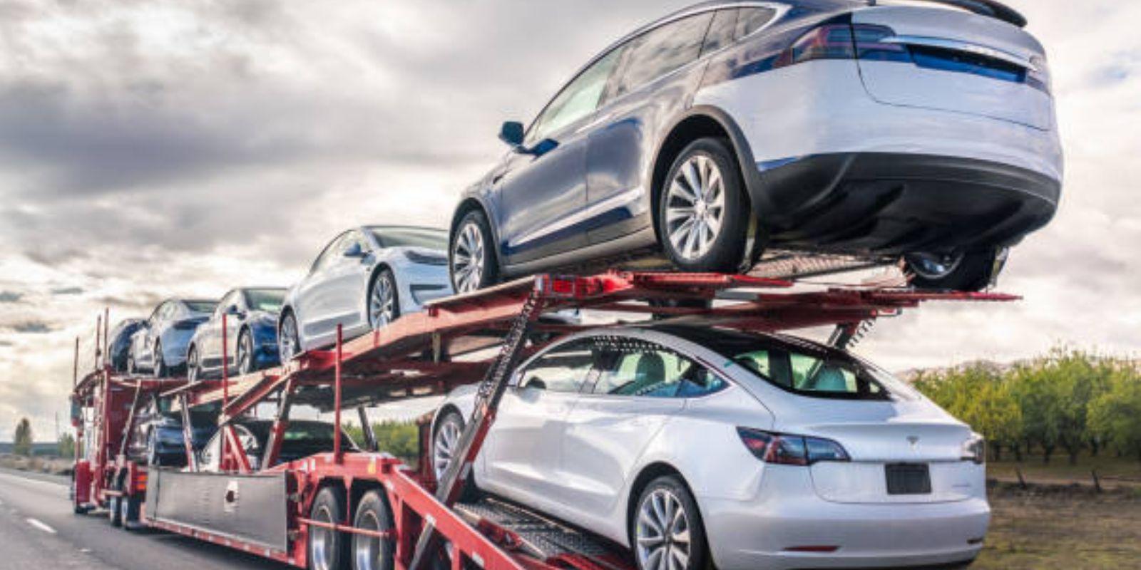 Cars loaded on a truk but question is that How can I avoid scams when I buy a used vehicle?
